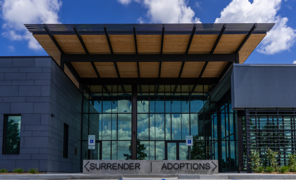 Main entrance of Lafayette Animal Shelter with SURRENDER and ADOPTIONS signage and glass facade